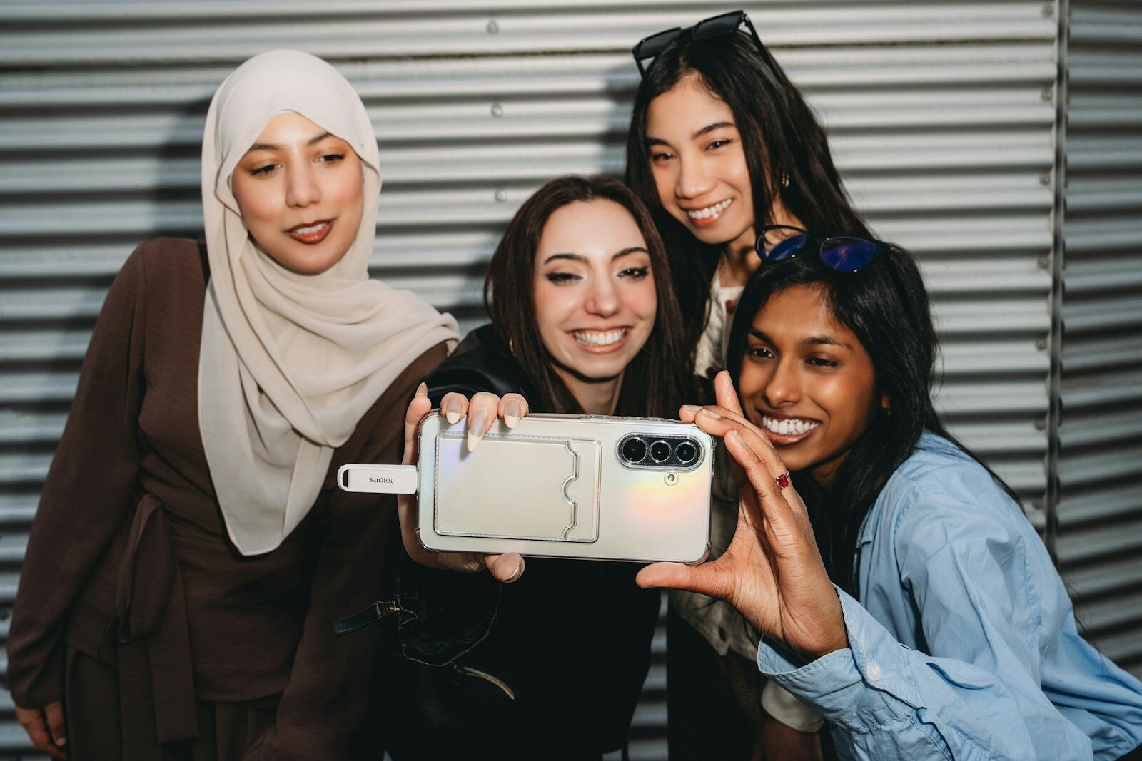 Diverse friends smiling while taking a selfie